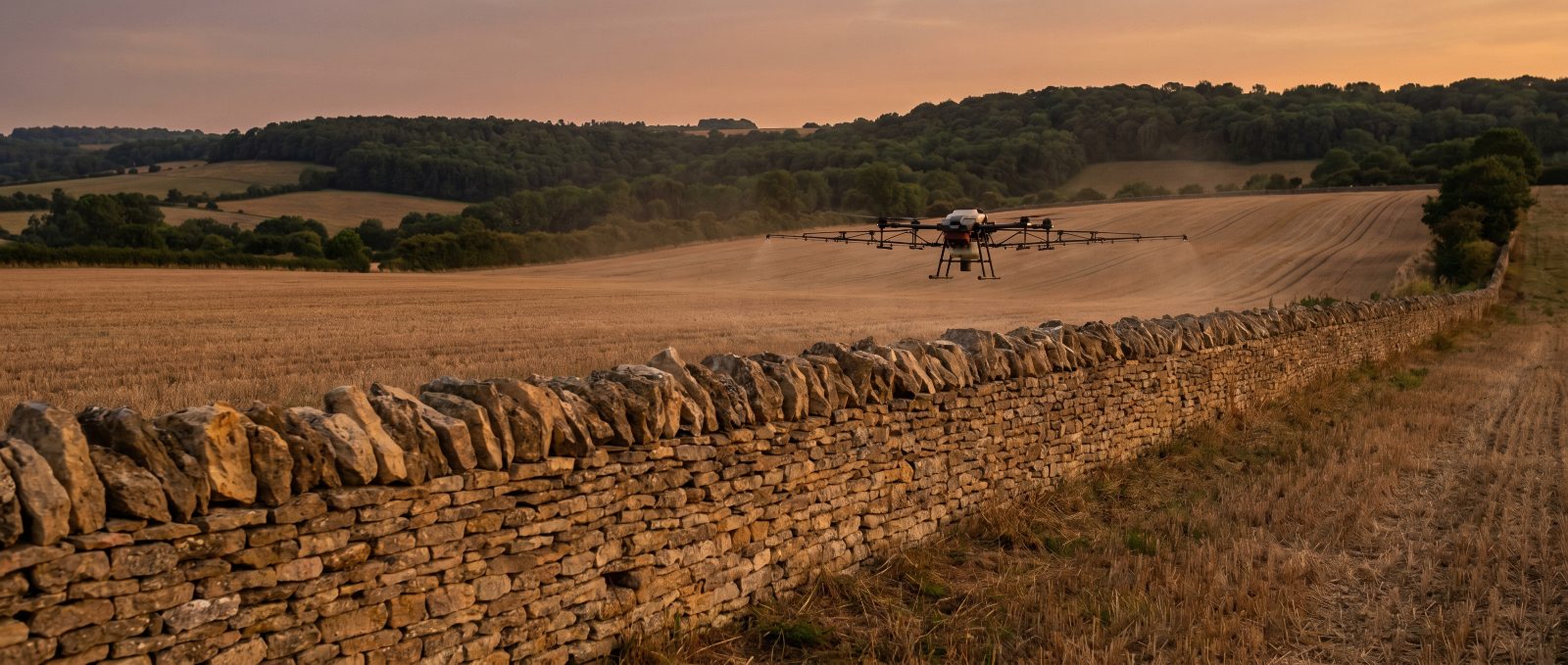 Agricultural spray drone working over Gloucestershire farmland