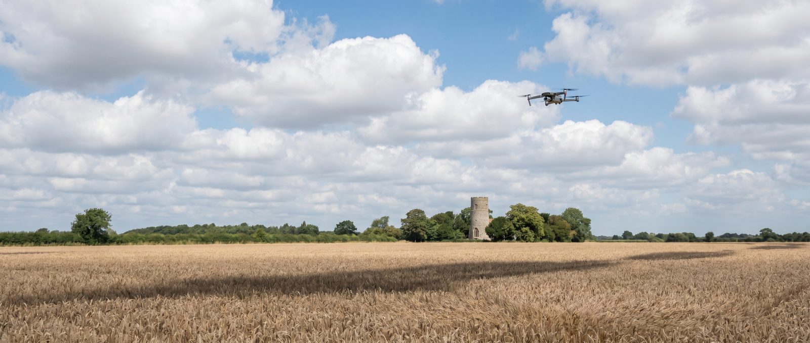 Agricultural spray drone working over Norfolk farmland