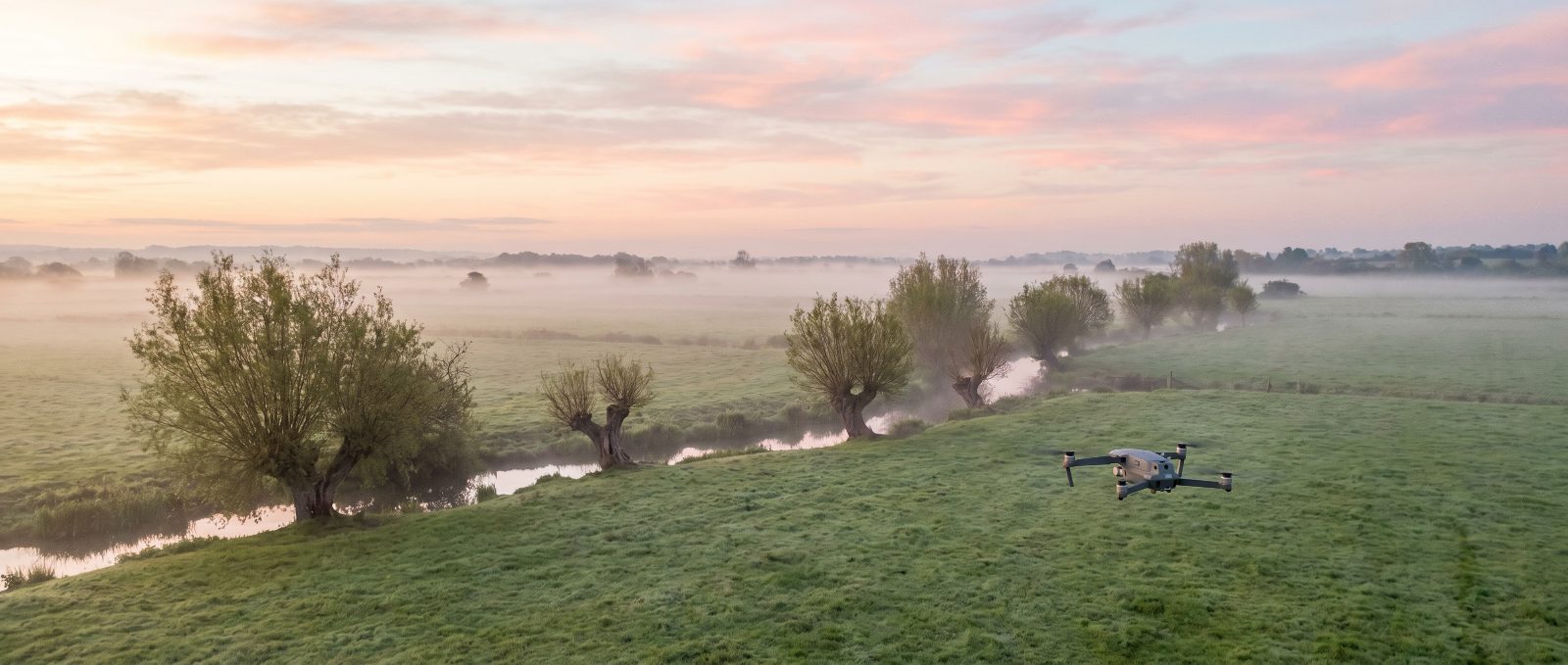 Agricultural spray drone working over Somerset farmland